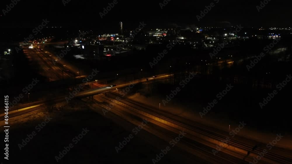 Top view over an expressway at night time.Top view over the highway,expressway and motorway at night with the view of a city in the background. Top view over an expressway at night time.Top view over the highway,expressway and motorway at night with the view of a city in the background.