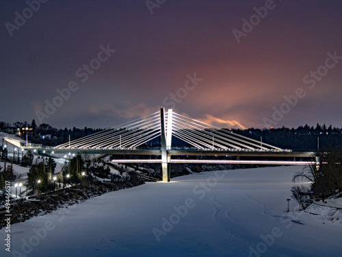 Beautiful night scene of Tilikum Crossing bridge over water against a dramatic colorful sky photo