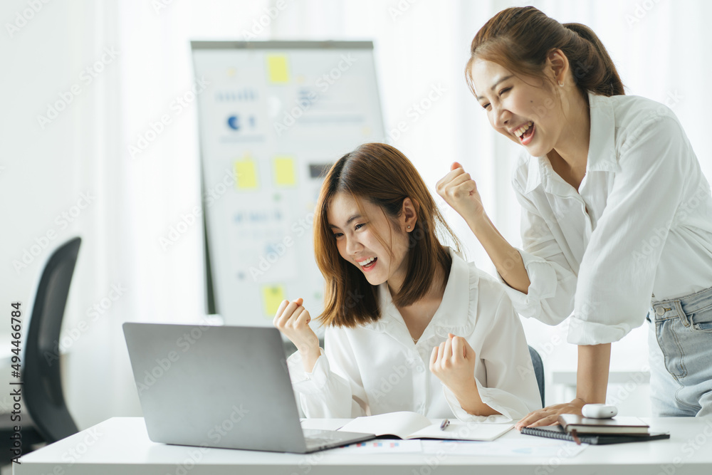 Happy excited successful businesswoman triumphing in office Happy excited successful businesswoman triumphing in office