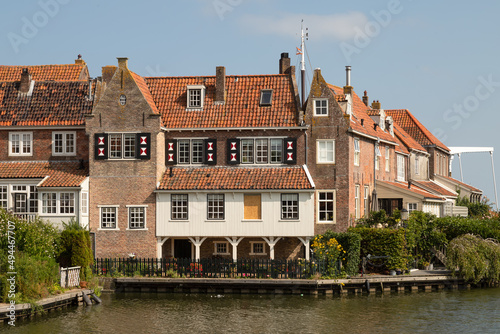 Historic canal houses on the old harbor of the picturesque town of Enkhuizen in West Friesland.