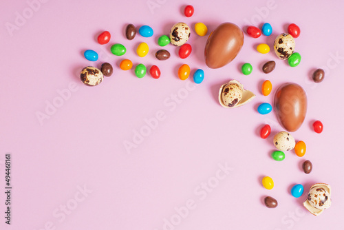 easter chocolate eggs on pink paper background