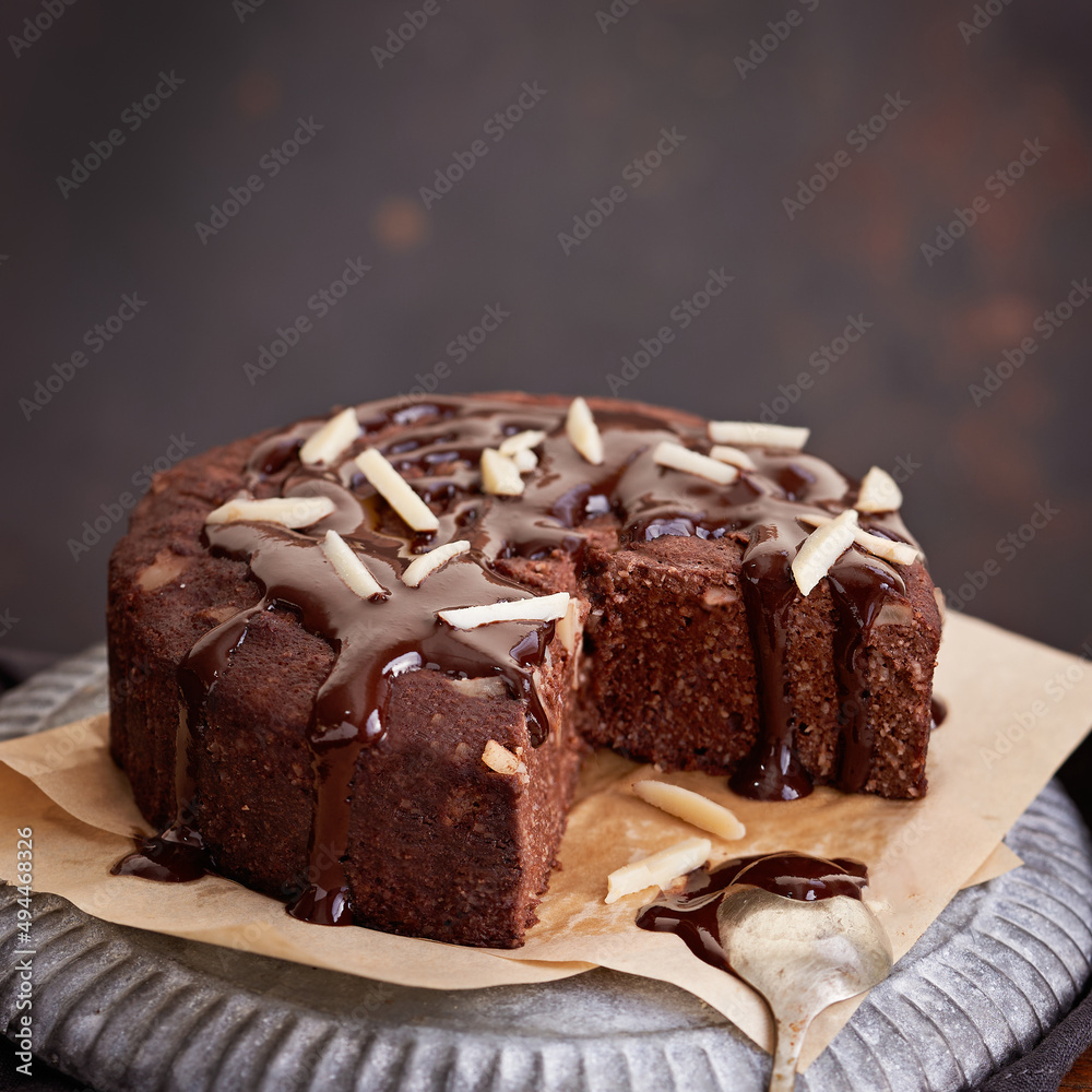 Healthy chocolate cake with almonds non sugar on a plate on the old wooden background. Selective focus. Keto diet.