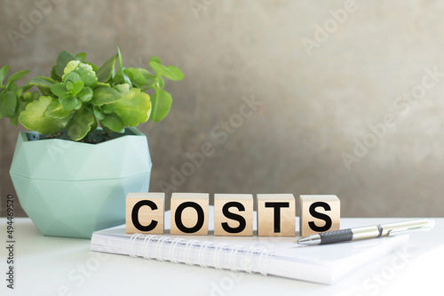 COSTS word on wooden cubes on an office desk, a business concept