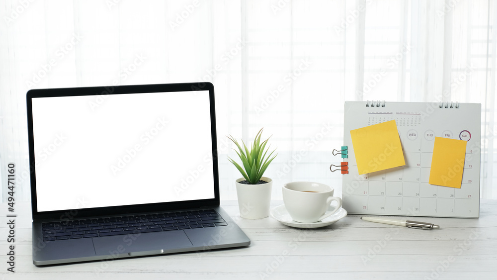 Blank white screen desktop laptop computer with coffee cup and stationery on vintage wooden table desk, social distance during quarantine, self-isolation, online education concept, Work from home Blank white screen desktop laptop computer with coffee cup and stationery on vintage wooden table desk, social distance during quarantine, self-isolation, online education concept, Work from home