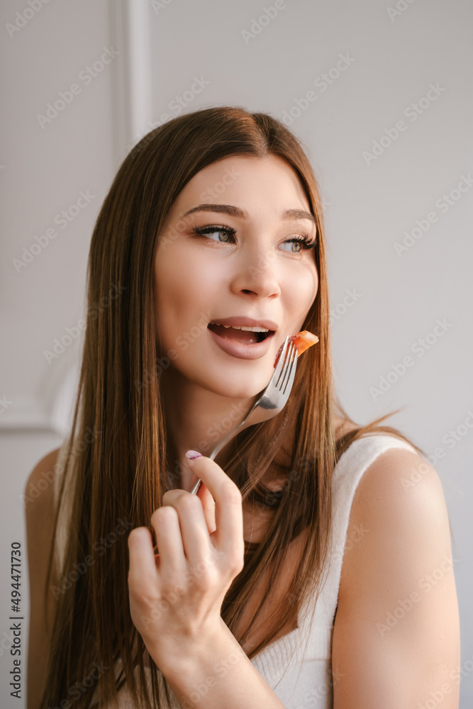 Young female freelancer having breakfast with curd fritters in a coffee shop Young female freelancer having breakfast with curd fritters in a coffee shop