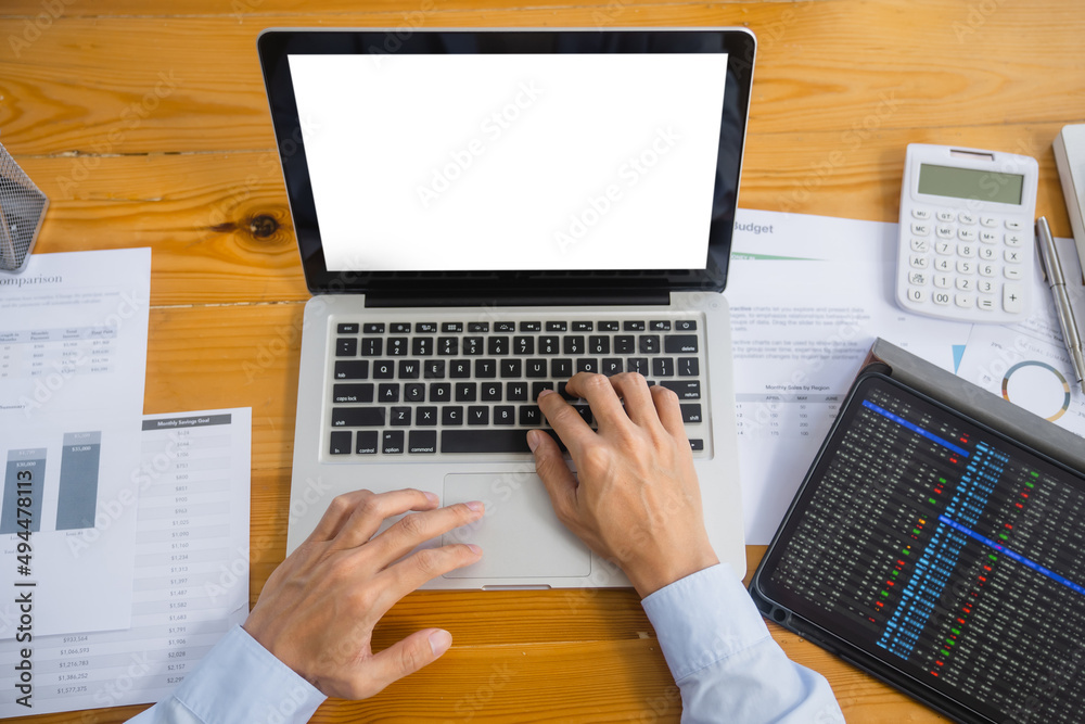 Close up of businessperson using laptop working with digital data.