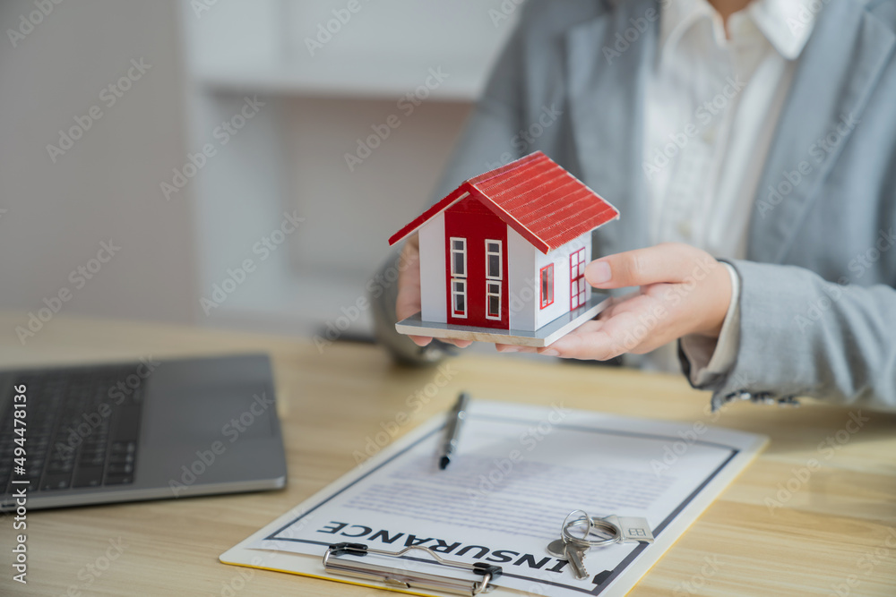 Fototapeta premium Property investment concept. Real estate broker with home insurance policy about house contract.