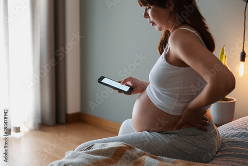 Pregnant woman calling medical assistance