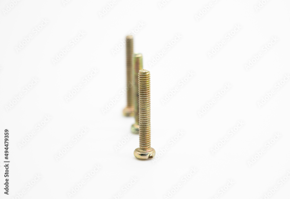Close-up of three screw in selective focus on white background