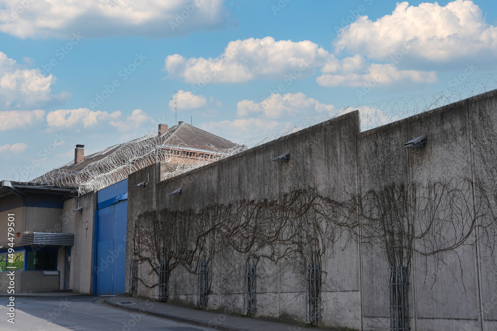 many rows of barbedwire, high concrete fence, barbed wire fence on top, building for execution of punishments for criminals, concept prison, security zone, symbol of bondage, hopelessness of captivity many rows of barbedwire, high concrete fence, barbed wire fence on top, building for execution of punishments for criminals, concept prison, security zone, symbol of bondage, hopelessness of captivity