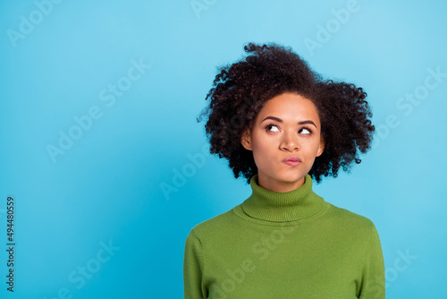 Portrait of focused minded person look interested empty space contemplate isolated on blue color background