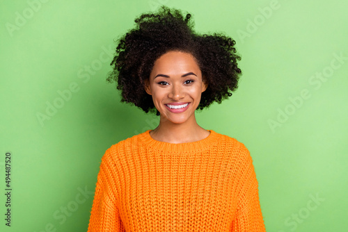 Photo of optimistic millennial volume hairdo lady wear orange sweater isolated on green color background