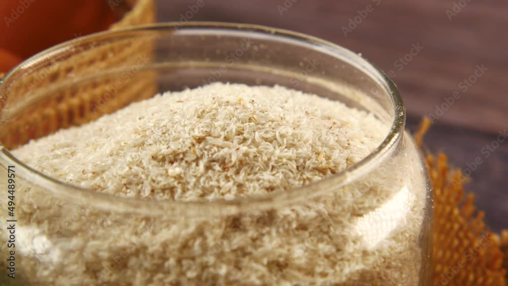 Psyllium Seeds in a glass container on table Psyllium Seeds in a glass container on table