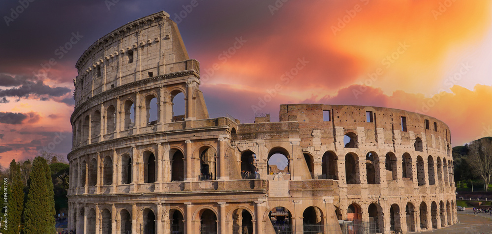 Colosseum at sunset with clouds and cypresses, Rome, Italy, High quality photo