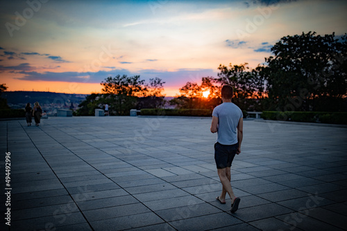 Evening view of a man from behind in a Vitkov park in Prague, Czech photo