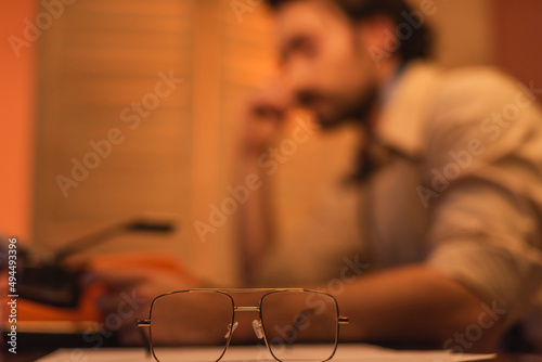 eyeglasses near blurred man on background.