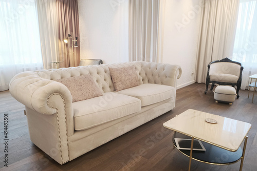 White leather sofa in the old style in the interior
