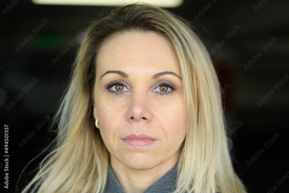 Fototapeta premium Woman staring thoughtfully at camera with closed lips