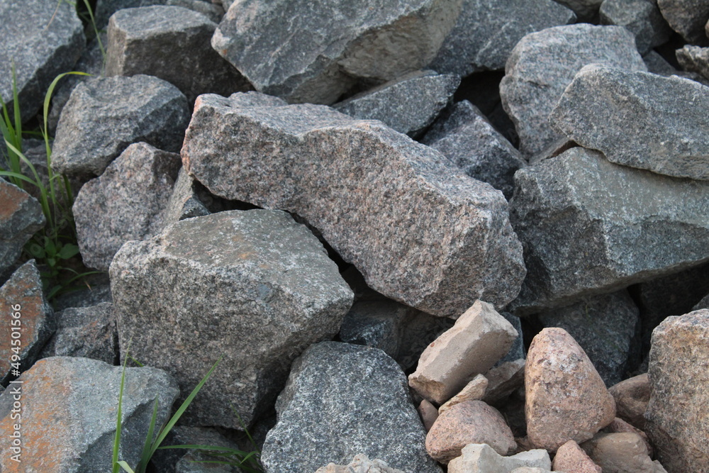 a background of cobblestone stones close-up. stones for the construction of the foundation. Crisis construction of expensive materials