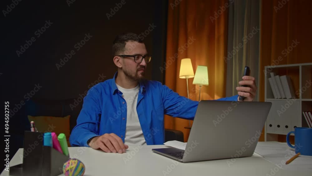 Caucasian male working from home, having a video call with colleagues. Stay home, quarantine remote work. Freelancer answering phone call during work Caucasian male working from home, having a video call with colleagues. Stay home, quarantine remote work. Freelancer answering phone call during work