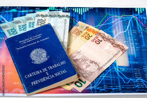work card and brazilian money over a graph photo