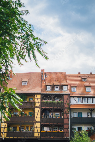 Vertical of antique buildings near the Kramerbrucke bridge in Erfurt, Germany photo