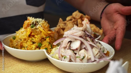 close-up of a marine trio of fish chicharron, seafood chaufa and ceviche in a restaurant on the beach during the day in 4k photo
