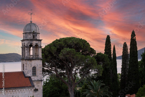 Savina Monastery - Serbian Orthodox monastery against the backdrop of a mountain range and the Bay of Kotor at sunset, the city of Herceg Novi, Montenegro.