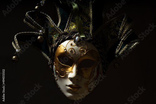 Venice carnival mask, Italy. Lit from the left on a black background
