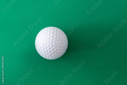 Golf ball on the green background