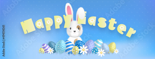 Happy Easter yellow text, with a cute white bunny behind colored eggs and flowers on a blue background