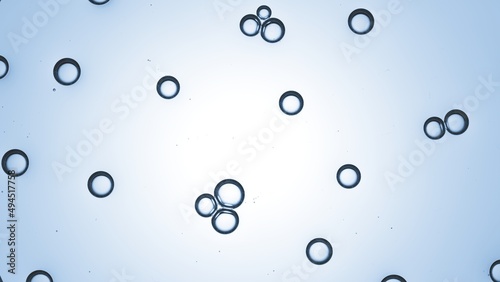 Macro shot of small bubbles of glycerol on pale blue background | Shot of moisturizer ingredients for its commercial