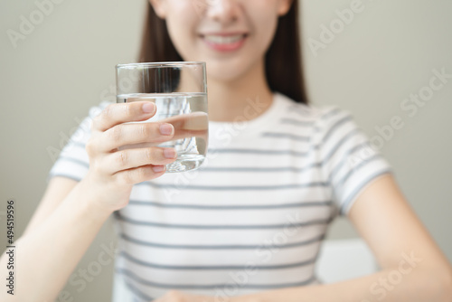 Clean freshwater concept. Woman drink mineral water in the morning for good health. © Pormezz