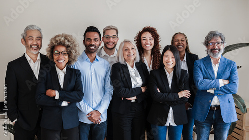 Tableau sur toile Multi-ethnic generational modern office: Successful business team smiling on cam