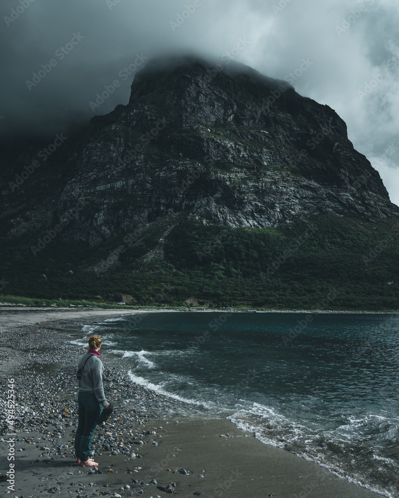 Fototapeta premium Shot of a girl discovering a natural green place and looking to mountain and sea view