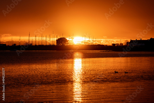 sun setting over the sea with Langstone bridge in the background	 photo