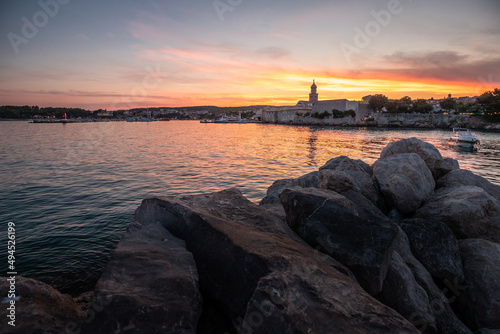 City of Krk  Croatia. Historical cityscape on Krk island with harbor cathedral and old town at sunset in summer.