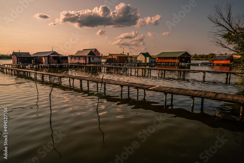 Fishing houses, holiday home, wooden house in the lake with jetty. Bokod Hungary Bora Bora landscape with sunset photo