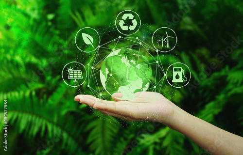 Technology, hand holding earth with environment Icons over the Network connection on a natural green background. 