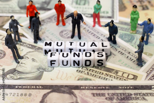 crowd of people and letter cube on dollar background. conceptual image for mutual fund, investment and financial.