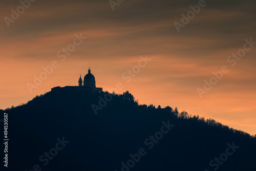 Silhouette of Superga Basilica upon a hill at sunset Italy photo
