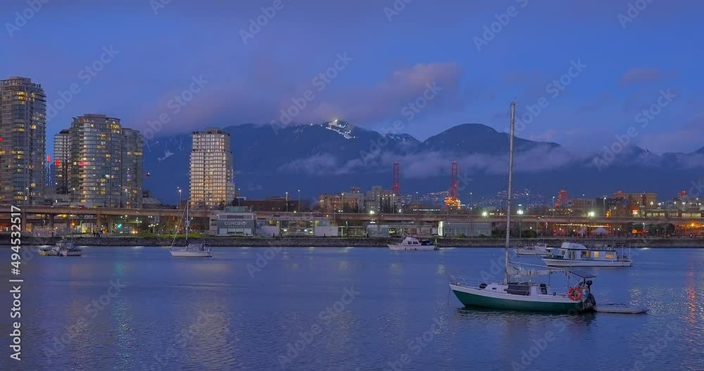 VANCOUVER, CANADA, MARCH 20, 2022: VIEW AT OCEAN HARBOR AT NIGHT IN THE CENTRE OF VANCOUVER. VANCOUVER, CANADA, MARCH 20, 2022: VIEW AT OCEAN HARBOR AT NIGHT IN THE CENTRE OF VANCOUVER.
