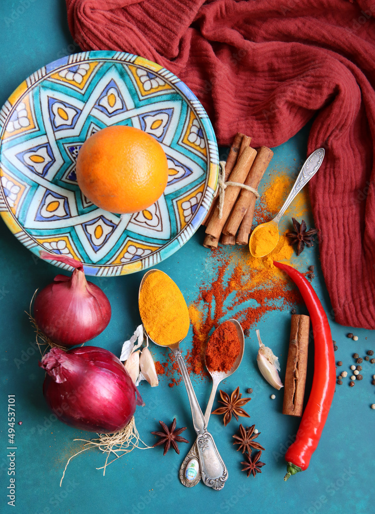 Oranges, red pepper, paprika powder, turmeric and anise top view photo. Spices on a table. Spicy meal preparation in process. Colorful still life with fruit. 
