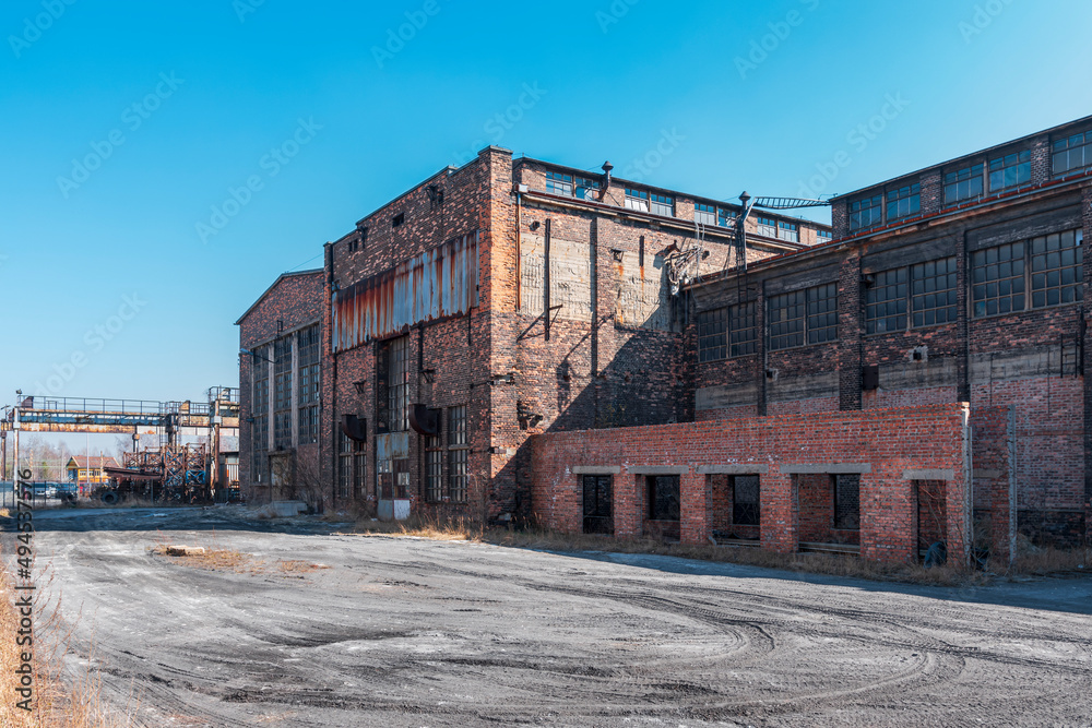 Old, rusted buildings located in Porcelain Factory (Fabryka Porcelany) in Katowice, Silesia, Poland. Industrial architecture from XIX_XX century.