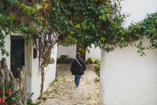 Chica joven guapa paseando y sonriendo por pueblo blando andaluz  photo