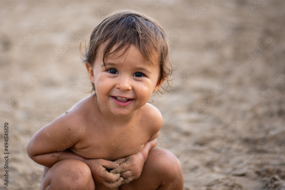 Portrait of cute little girl play with sand on the beach Portrait of cute little girl play with sand on the beach