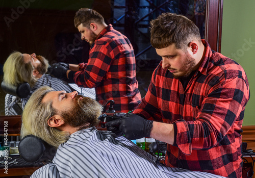 Making hair look magical. male beauty and fashion. mature man at barbershop. brutal bearded man at hairdresser. barber with male client. hipster with dyed beard and moustache. man want new hairstyle © be free