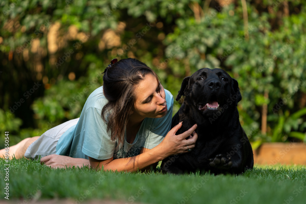 Wife Cuddling a teddy bear Labrador. Positive emotions showing the attachment between wife and pet love and trust and absolute endearment and enjoyment of the attention given Wife Cuddling a teddy bear Labrador. Positive emotions showing the attachment between wife and pet love and trust and absolute endearment and enjoyment of the attention given