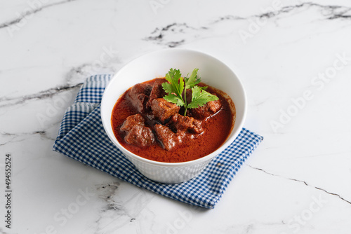 Mutton Rogan Josh, mutten qorma, mutten curry, mutton karahi in a dish isolated on napkin side view on grey background photo