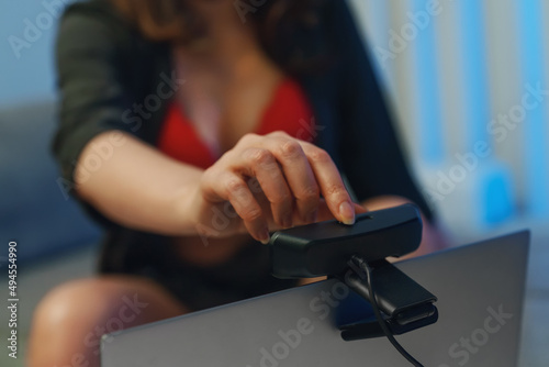 Woman in red underwear working as webcam model in studio. photo